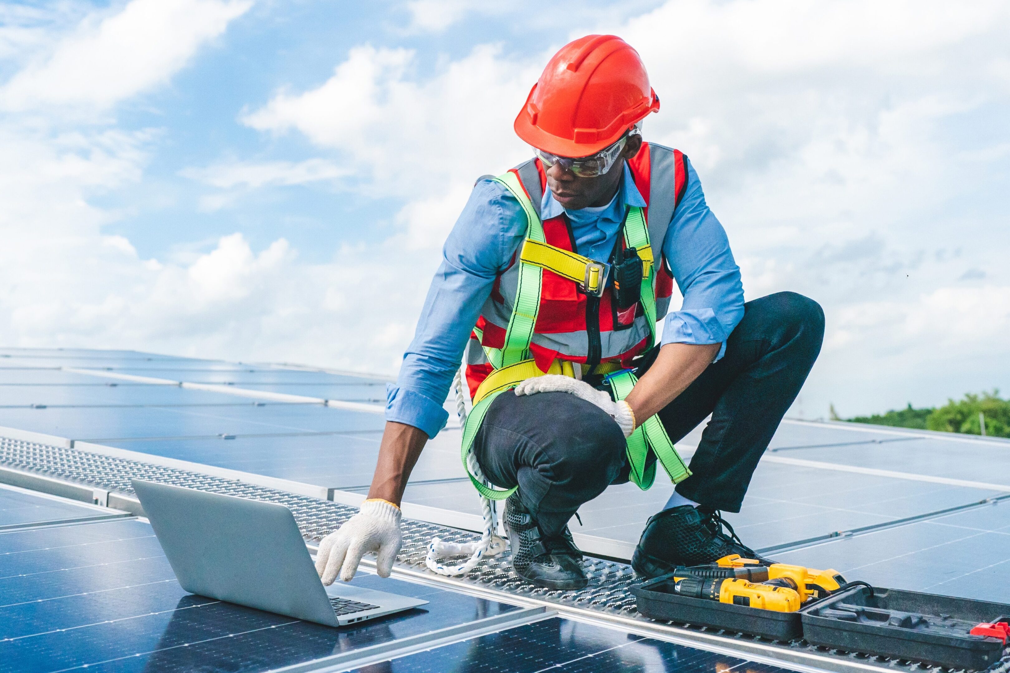 African,American,Engineer,Maintaining,Solar,Cell,Panels,On,Factory,Building