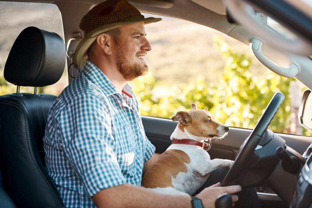 Farmer driving a truck with his dog