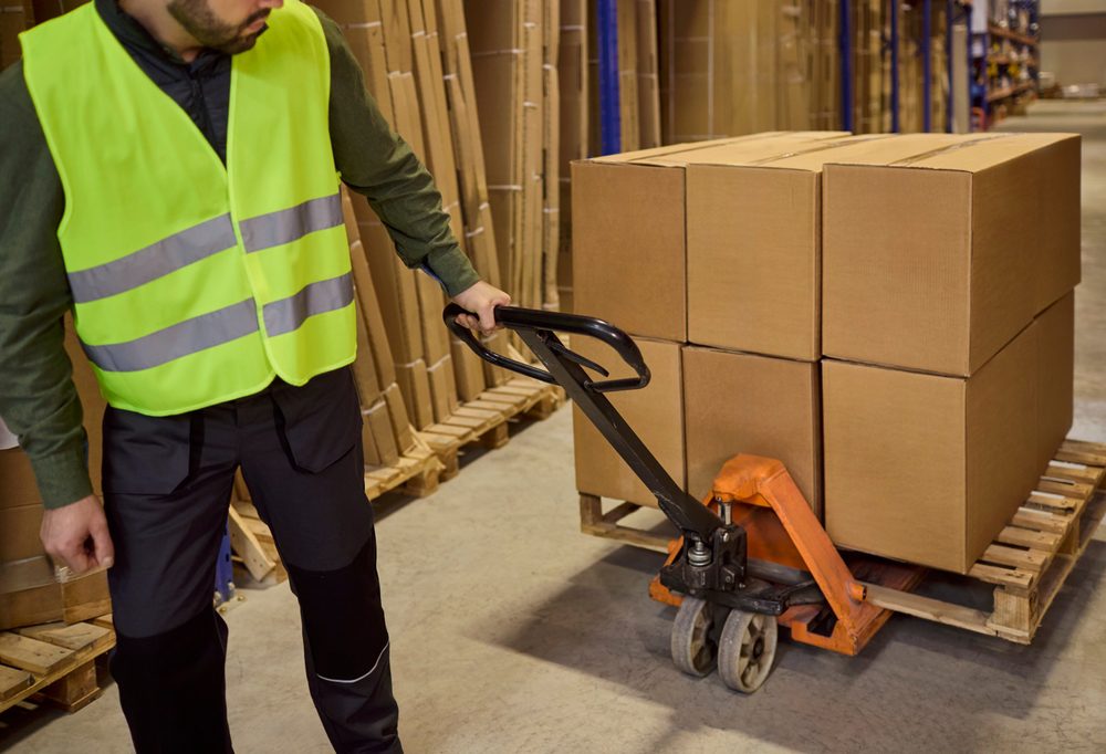 Worker moving goods on a pallet