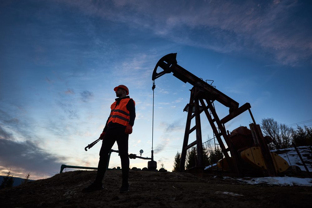 Oil worker at dawn