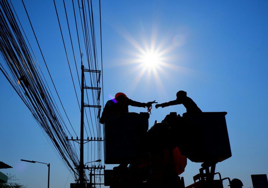 Electricians at work on outside lines