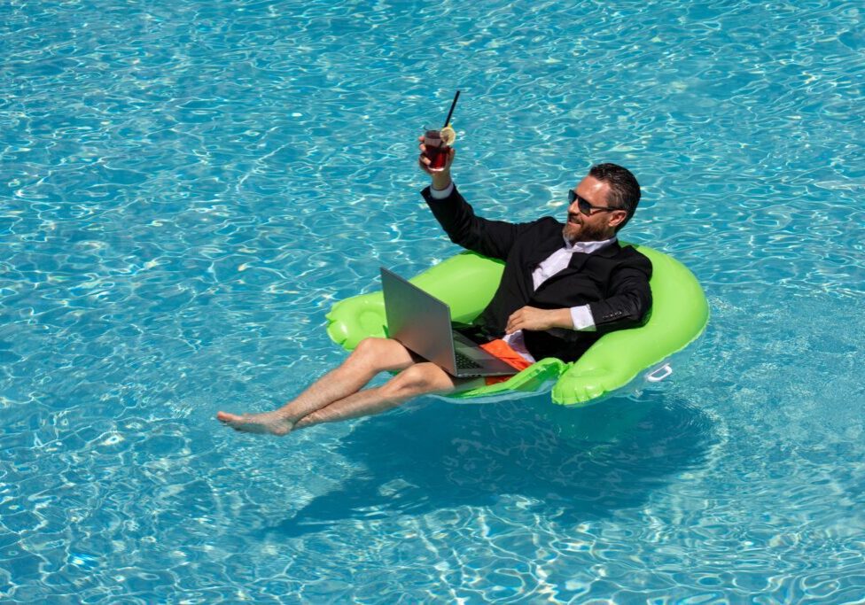 Businessman in suit floating in a pool