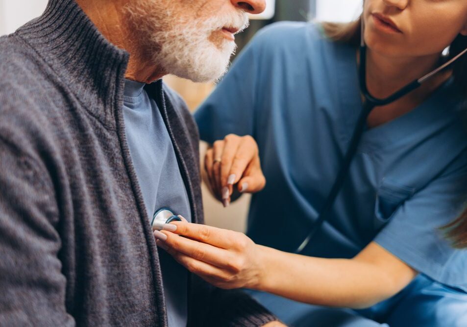 Home healthcare worker using stethoscope